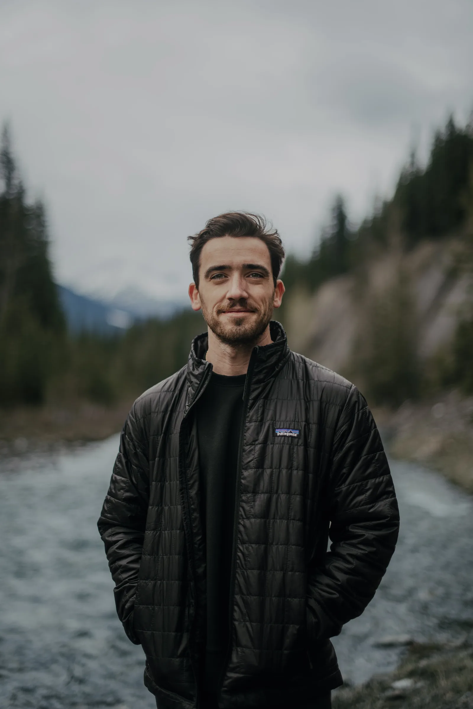 Mike Mona standing by a mountain river